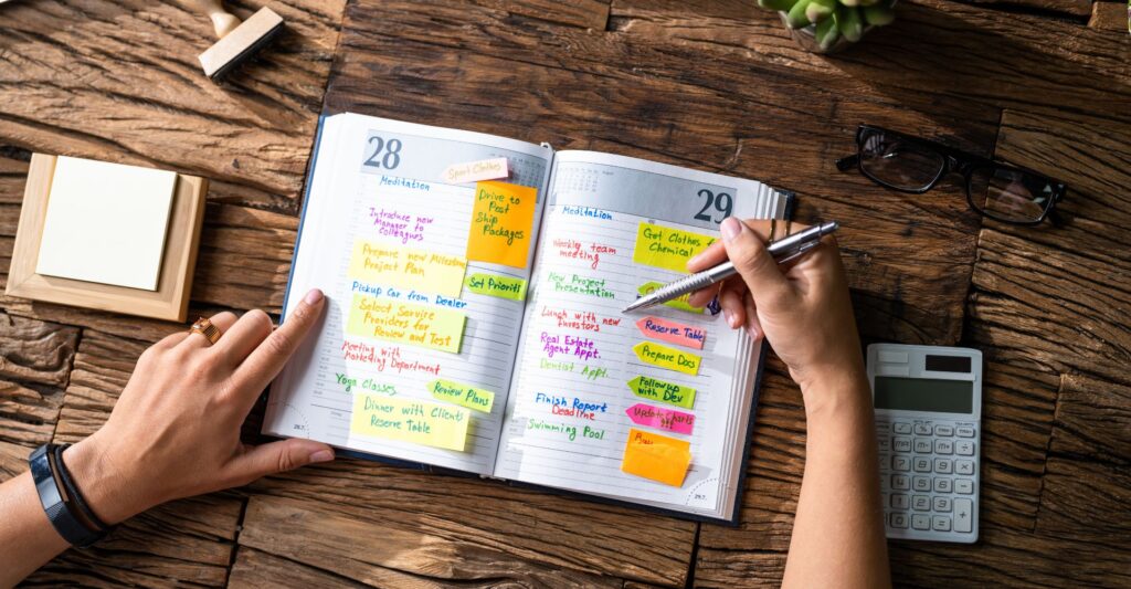 Person writing creative business ideas on sticky notes during a brainstorming session.