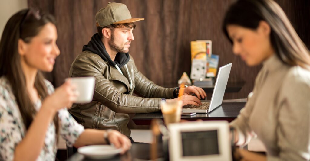 Freelancer working in a cafe and planning a digital product idea