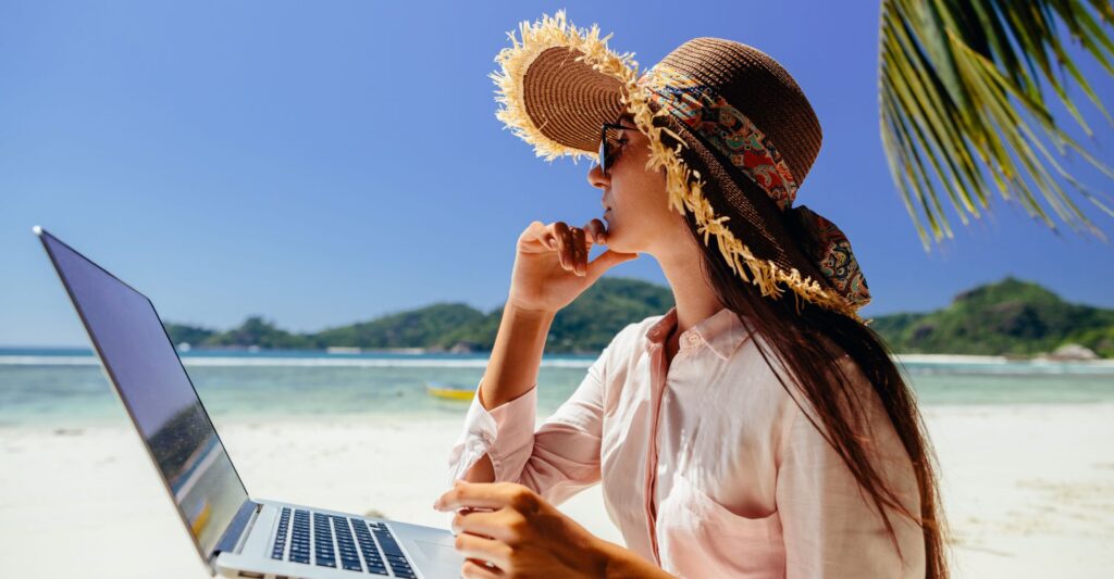 Freelancer working remotely from a tropical place with a laptop