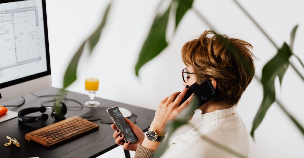 Stressed remote worker surrounded by devices, struggling to concentrate
