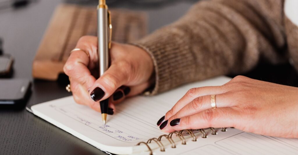 Woman journaling her time blocks during a mindful morning routine